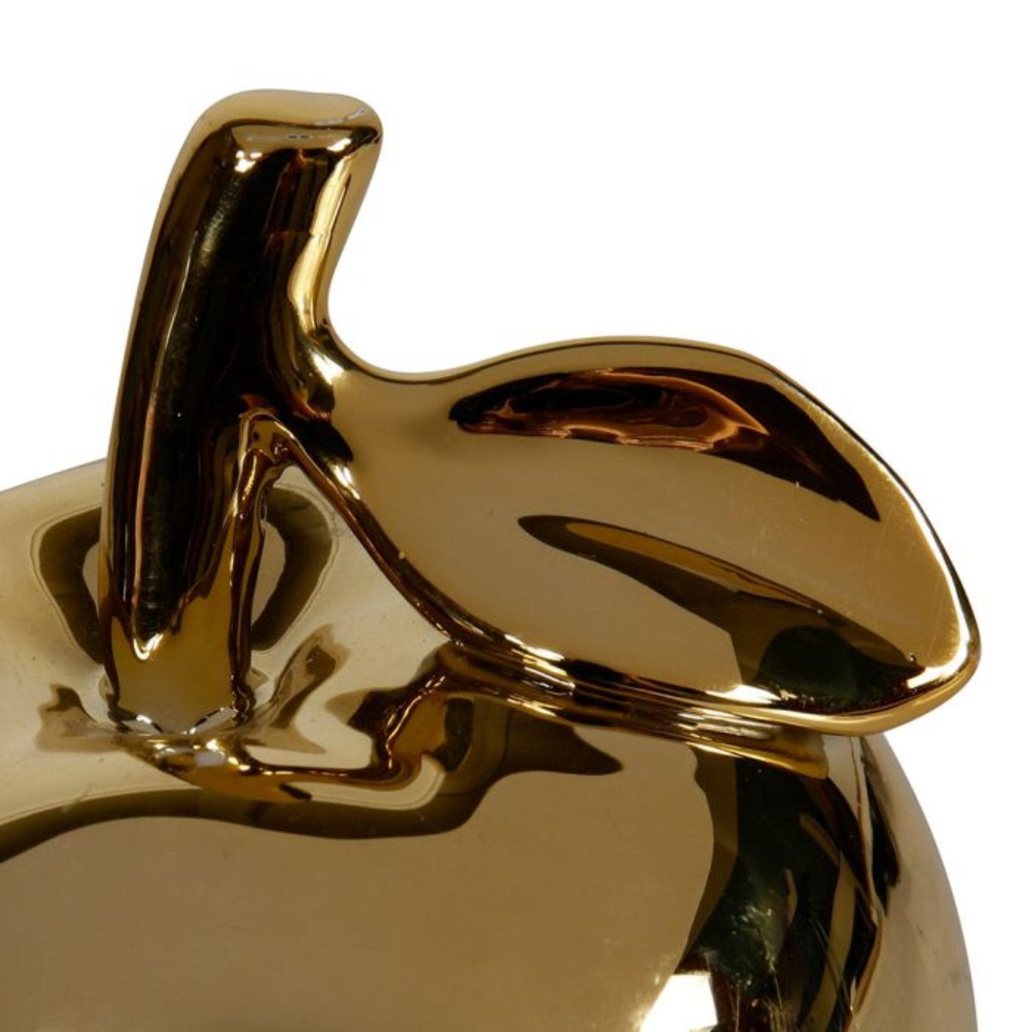 Pomme en céramique dorée, ajoutant élégance et sophistication à la décoration intérieure.