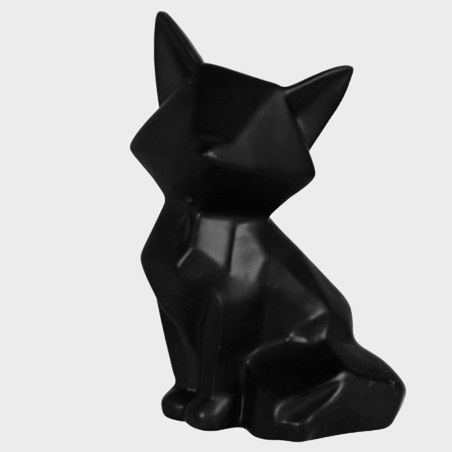 Statuette en céramique représentant un renard noir, ajoutant originalité et charme à la décoration intérieure.