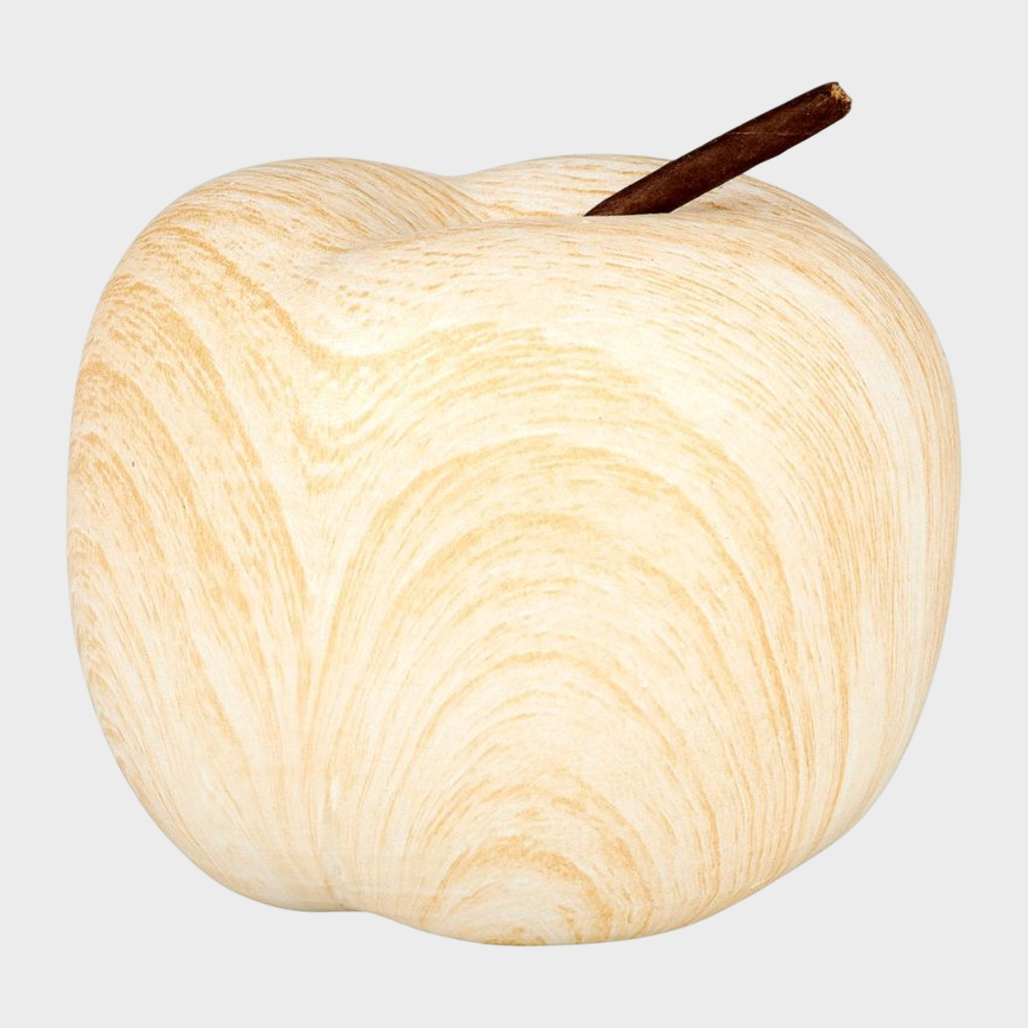 Pomme décorative en céramique blanche posée sur une table, ajoutant une touche de charme et d'élégance.