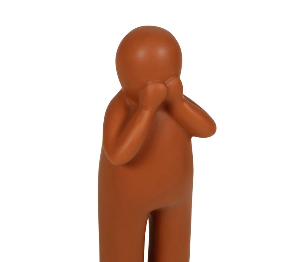 Figurines en céramique de personnages noirs, blancs et oranges, apportant une touche amusante et originale à la décoration intérieure.